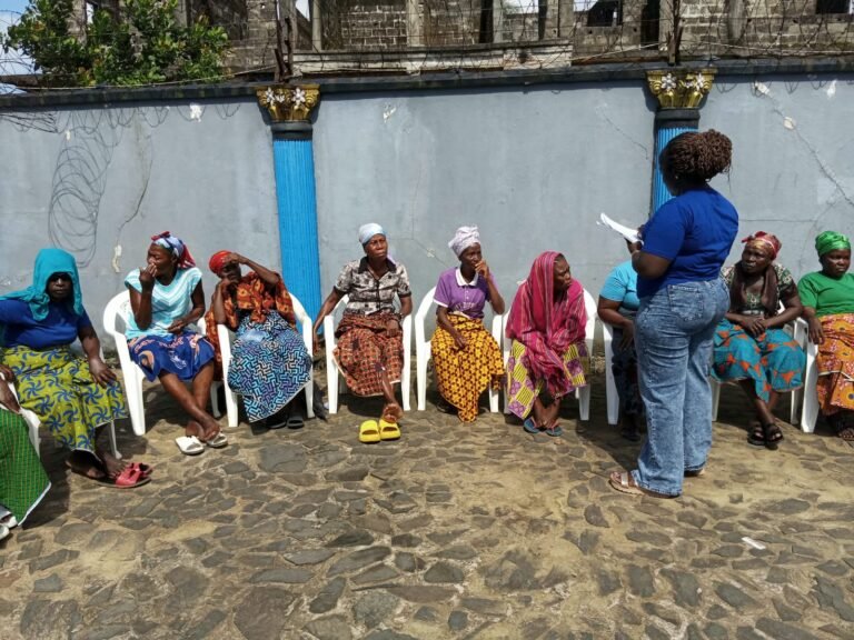 A facilitator speaking with participants during the training